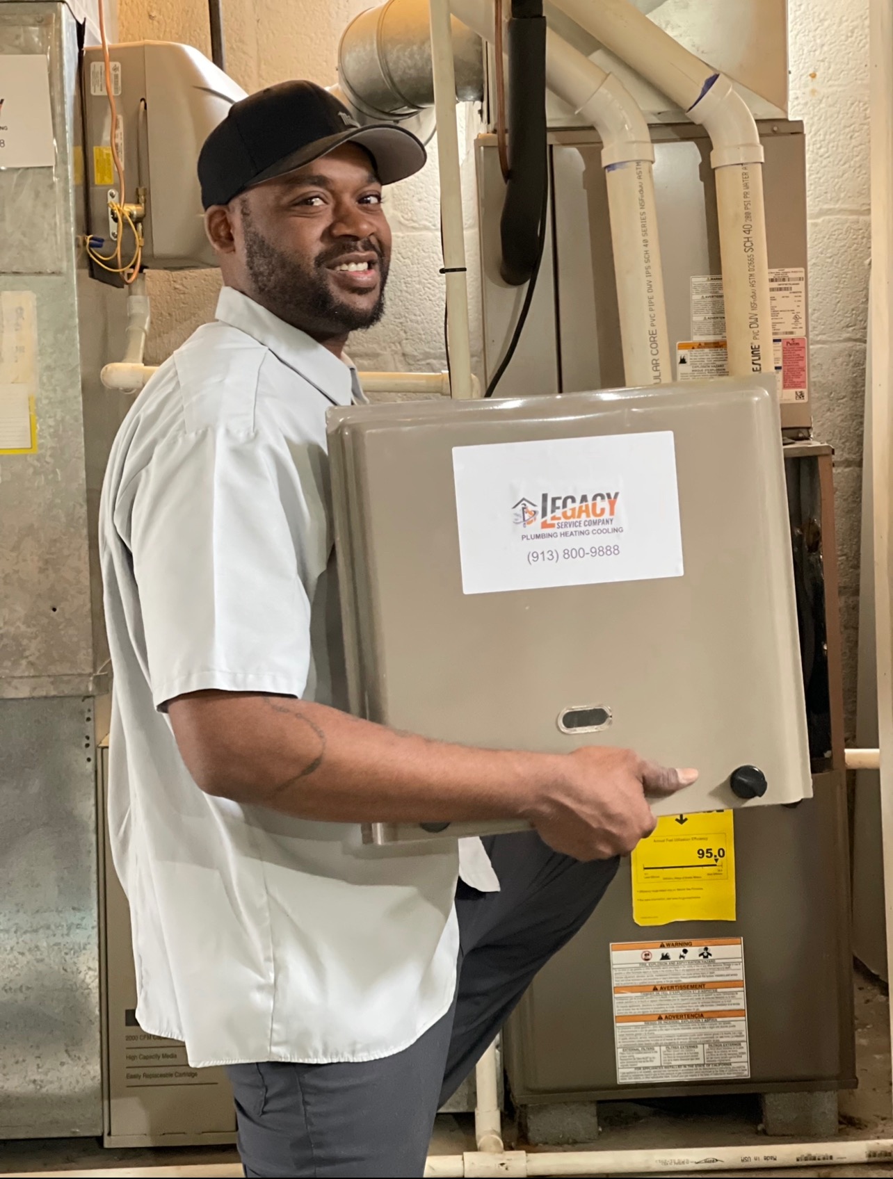 DeMarkus Paul, Founder and CEO of Legacy Service Academy, working beside residential HVAC equipment